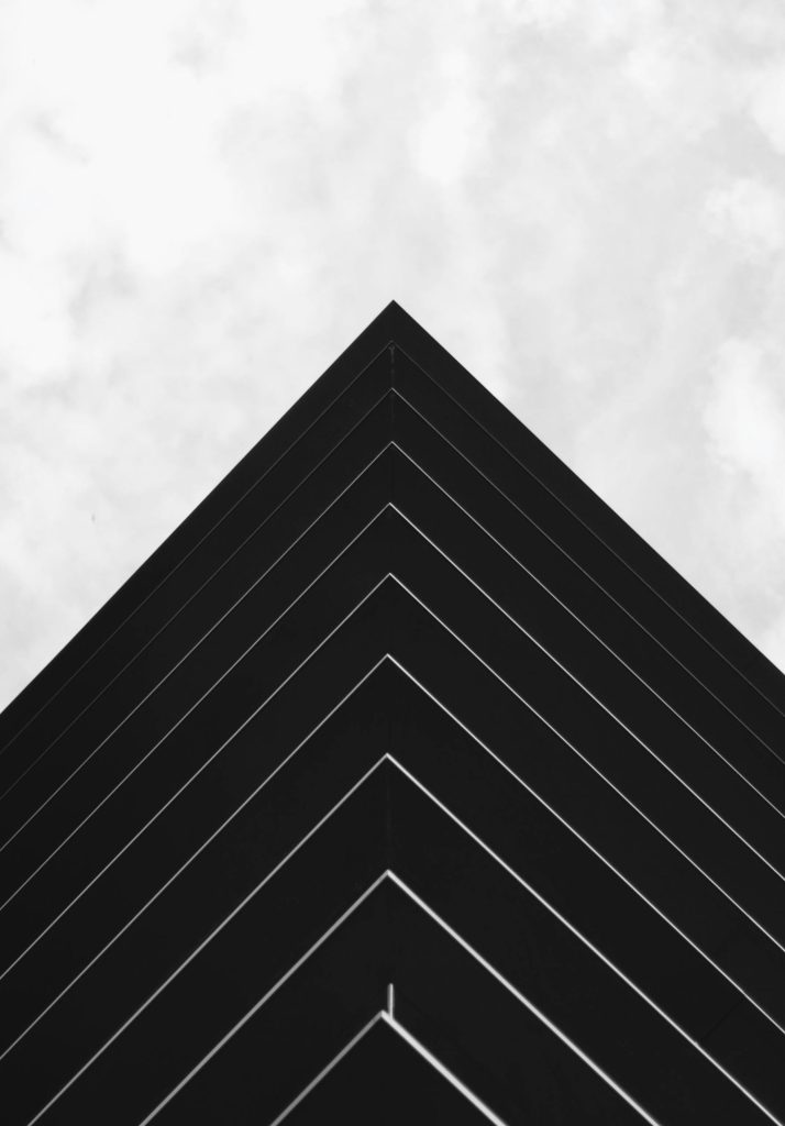 Abstract perspective of a building's symmetrical lines in black and white, showcasing modern architecture.